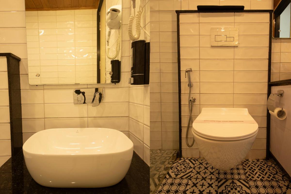 a bathroom with a toilet and a phone at Perfectstayz Premium Westend at Mall Road in Mussoorie