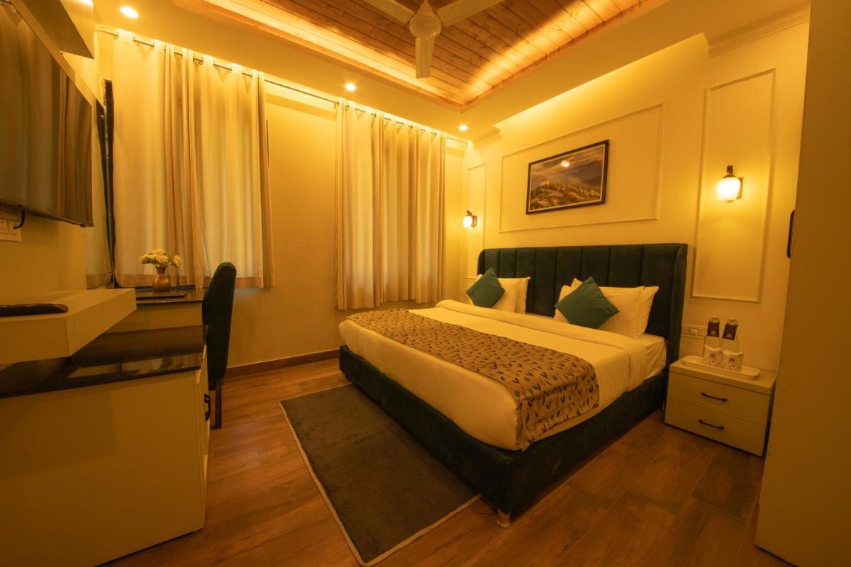 a hotel room with a bed and a sink at Perfectstayz Premium Westend at Mall Road in Mussoorie