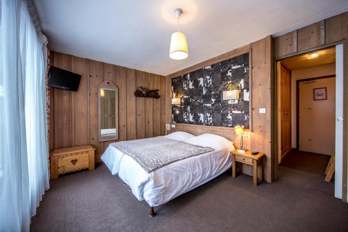 Un ou plusieurs lits dans un hébergement de l'établissement Logis Hotel Gai Soleil