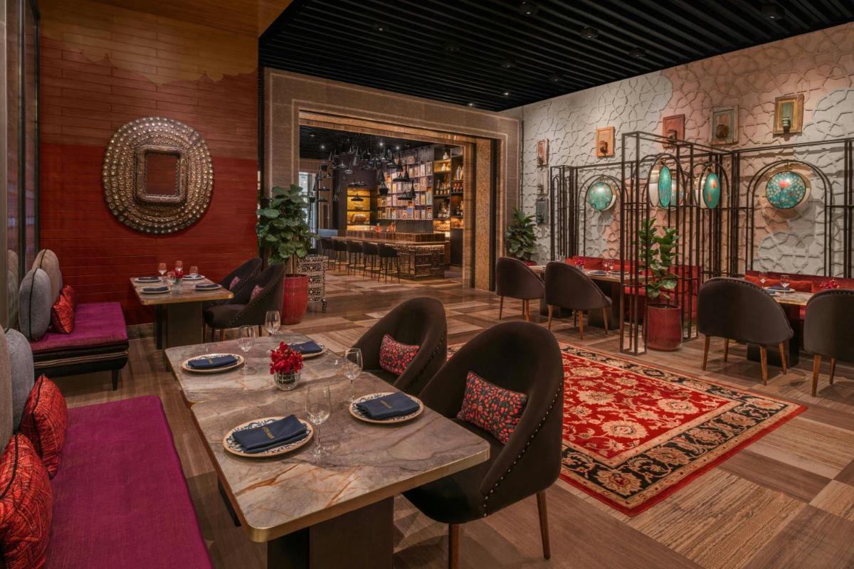 a dining room with a table and chairs at The St. Regis Mumbai in Mumbai