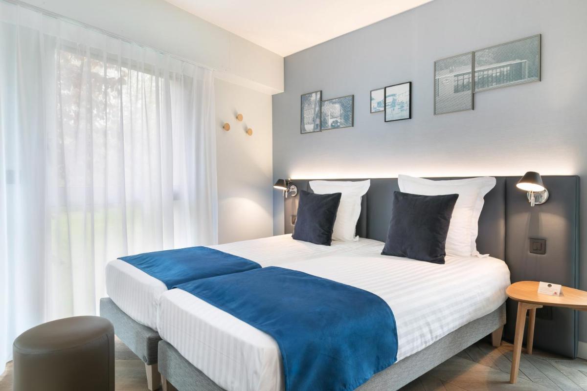 Un ou plusieurs lits dans un hébergement de l'établissement Hôtel Diana Restaurant & Spa by HappyCulture