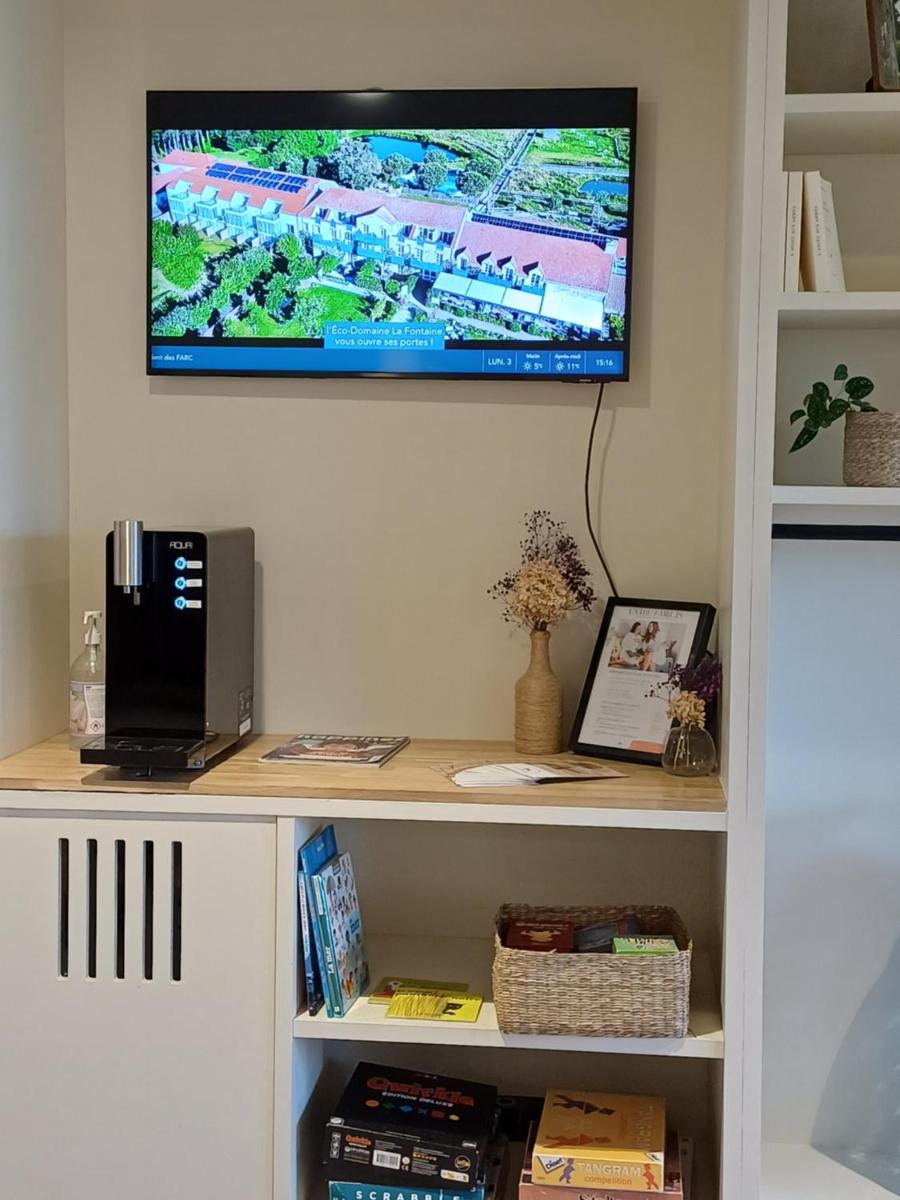 Télévision ou salle de divertissement dans l'établissement Eco-Domaine La Fontaine - HOTEL-SPA - 300 m Plage de la Fontaine aux Bretons