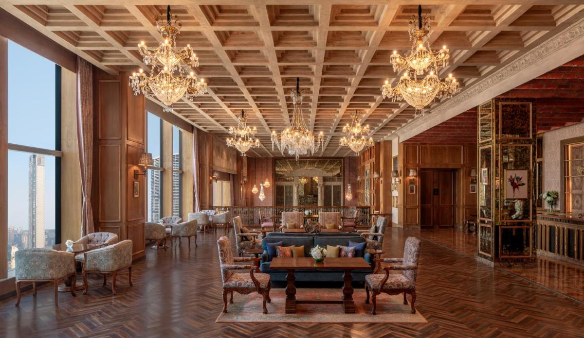a large room with chandeliers and a couch and a table at The St. Regis Mumbai in Mumbai