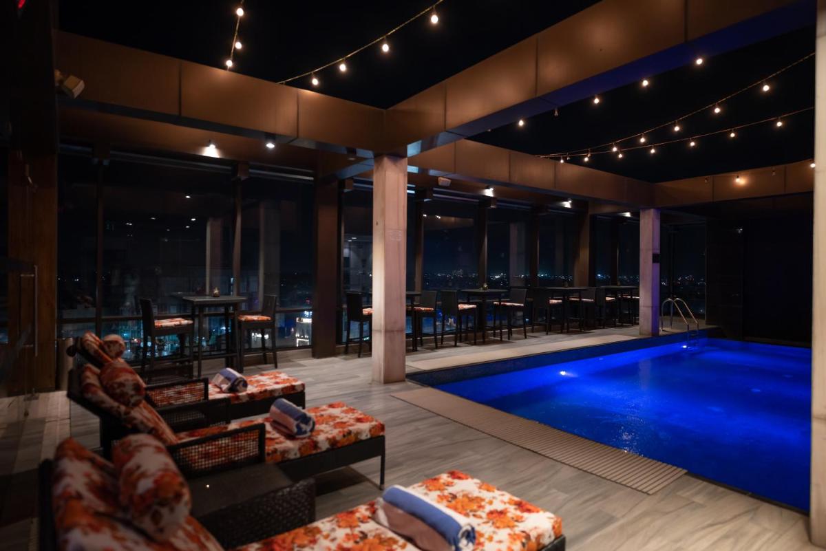 a hotel with a swimming pool and a restaurant at Courtyard by Marriott Amritsar in Amritsar