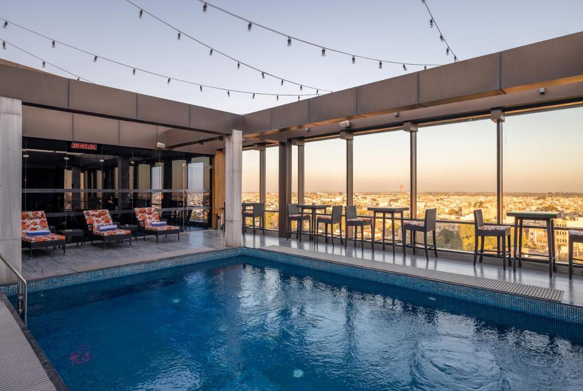 a swimming pool on top of a building with a view at Courtyard by Marriott Amritsar in Amritsar
