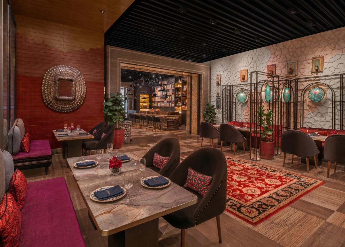 a dining room with a table and chairs at The St. Regis Mumbai in Mumbai