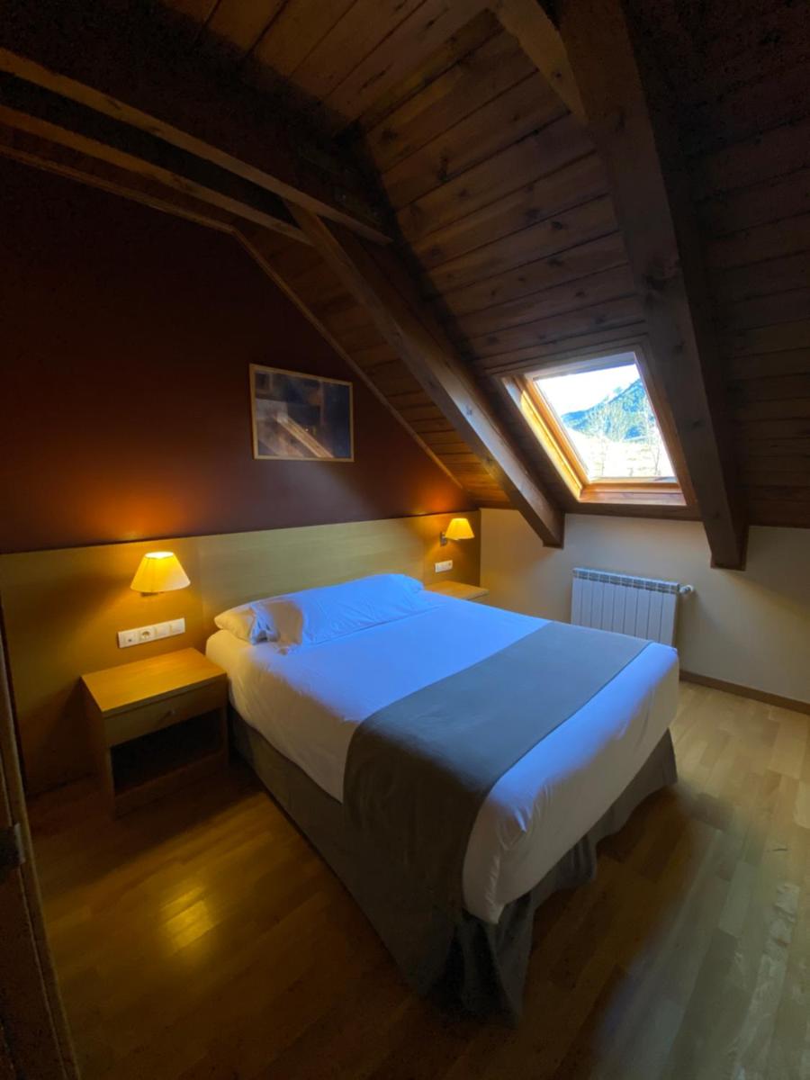 Cama o camas de una habitación en Aparthotel Siente Boí & SPA