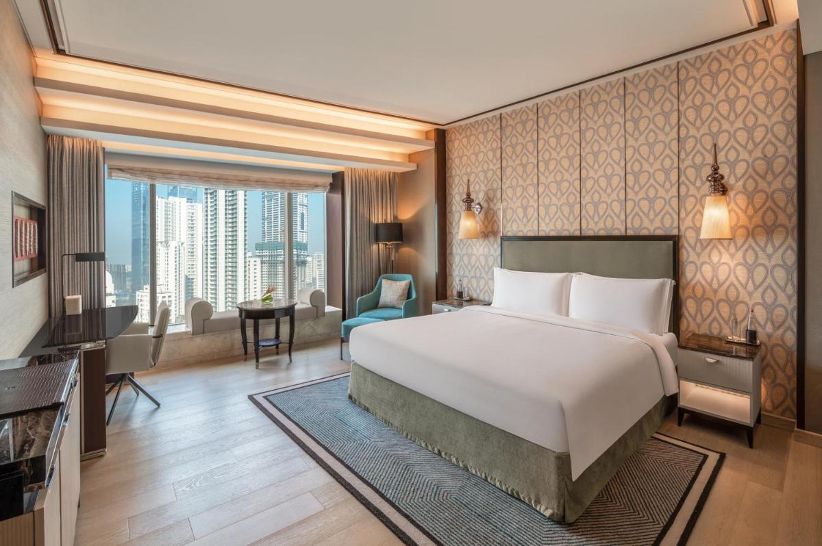 a hotel room with a bed and a large window at The St. Regis Mumbai in Mumbai