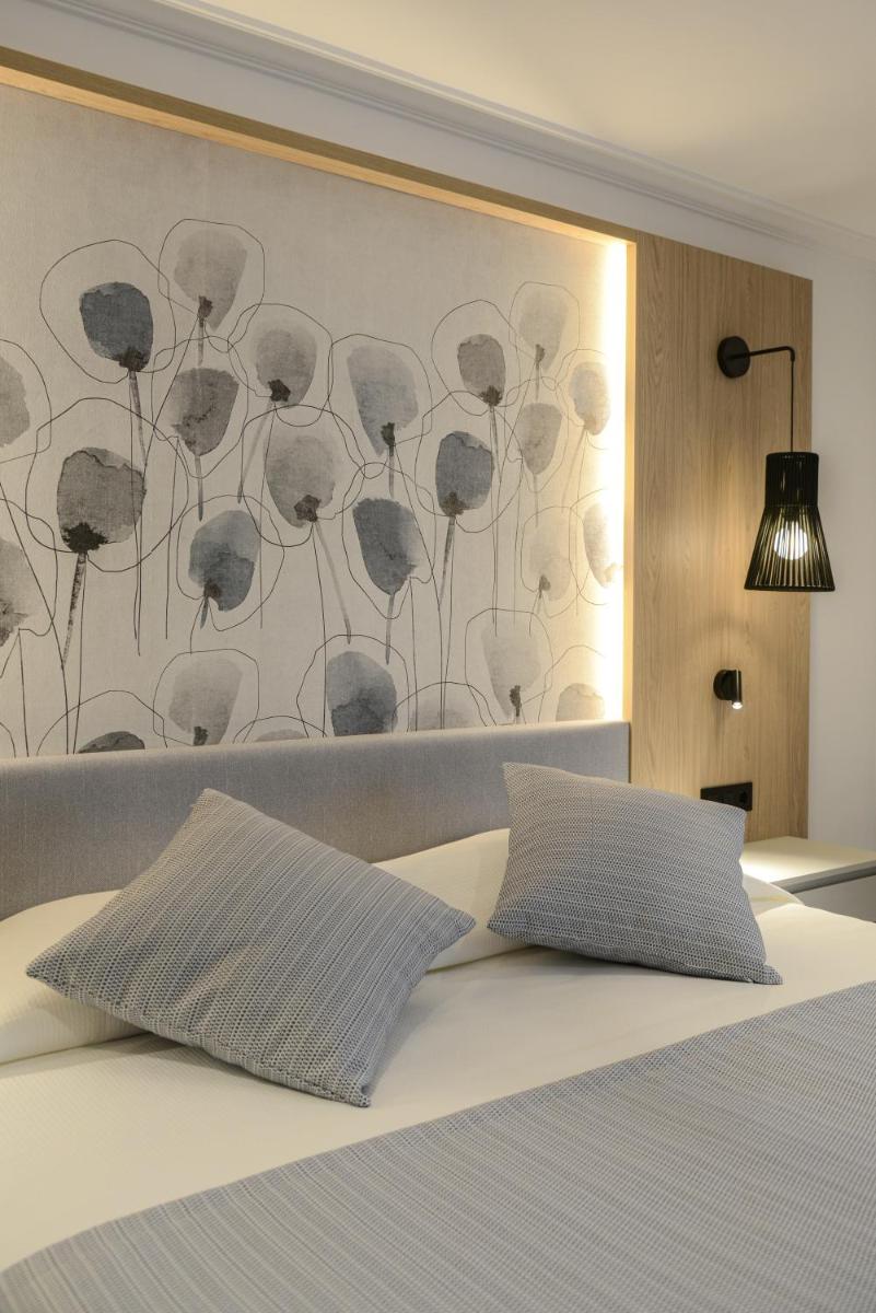 Cama o camas de una habitación en Hotel Capricho