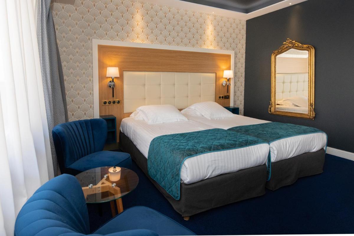 Un ou plusieurs lits dans un hébergement de l'établissement Splendid Hotel & Spa Nice