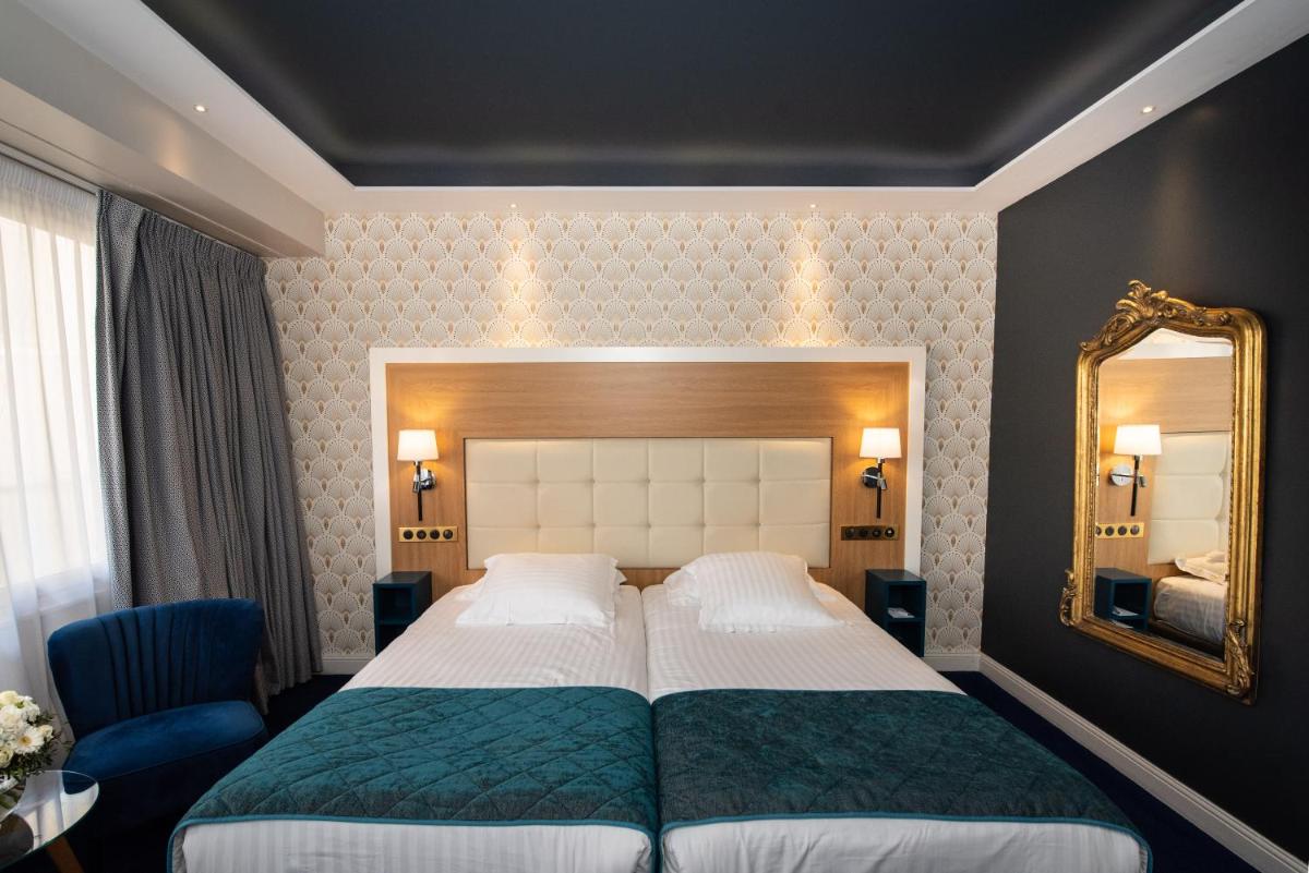 Un ou plusieurs lits dans un hébergement de l'établissement Splendid Hotel & Spa Nice