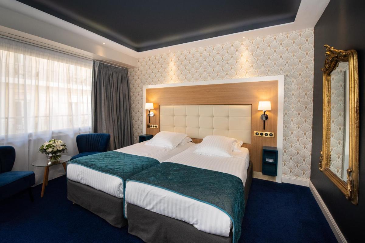 Un ou plusieurs lits dans un hébergement de l'établissement Splendid Hotel & Spa Nice