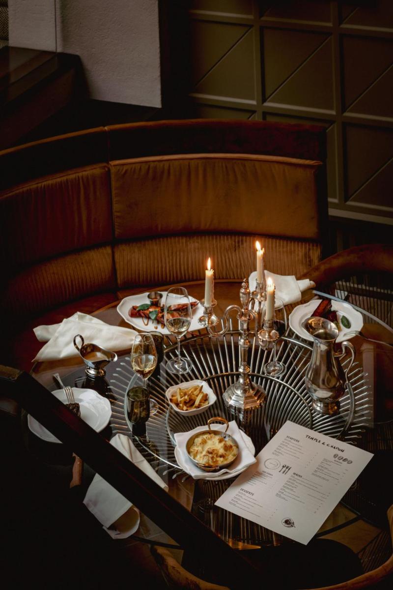 - une table avec des assiettes de nourriture et des bougies dans l'établissement Experimental Marais, à Paris
