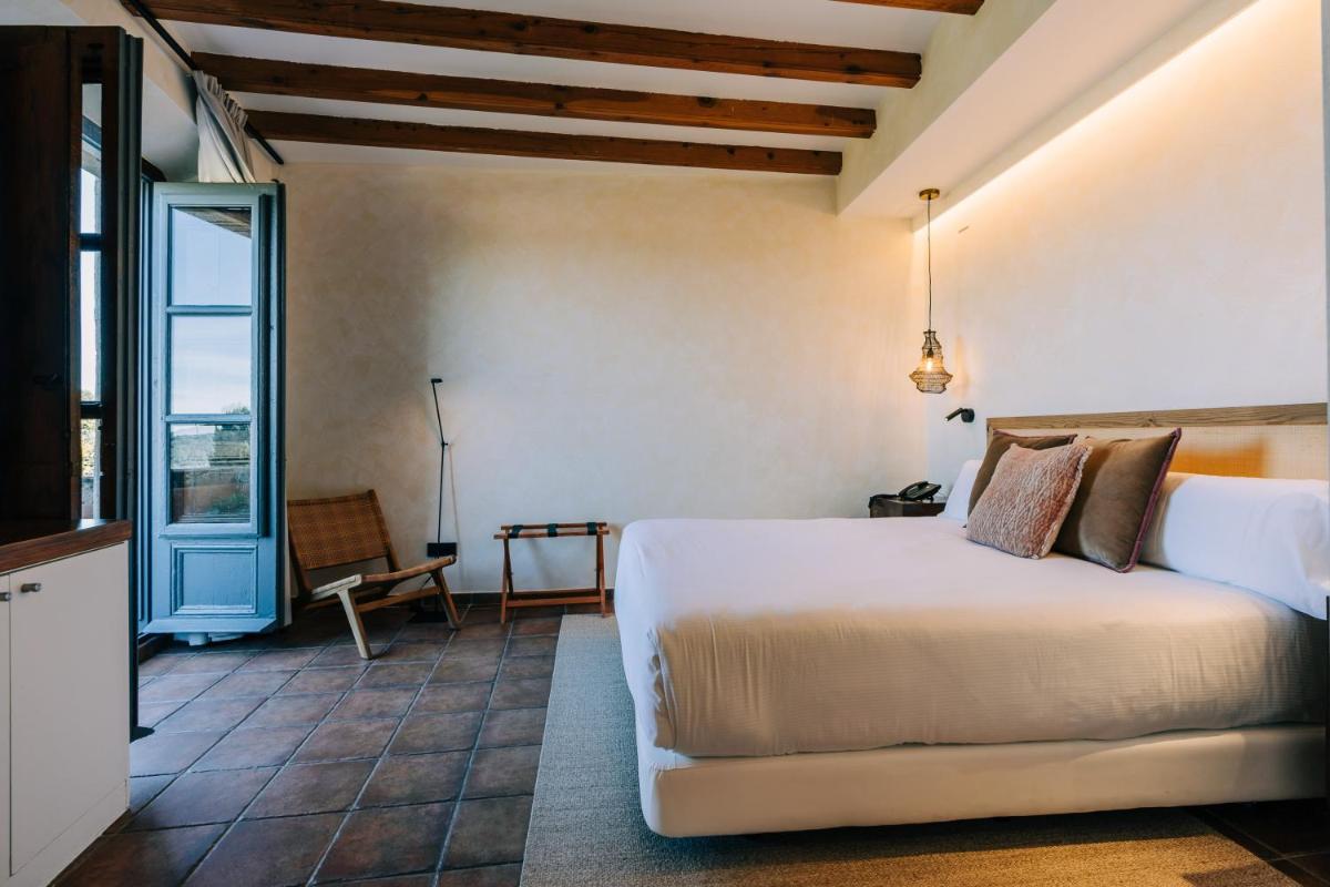 Cama o camas de una habitación en Gran Claustre Boutique Hotel