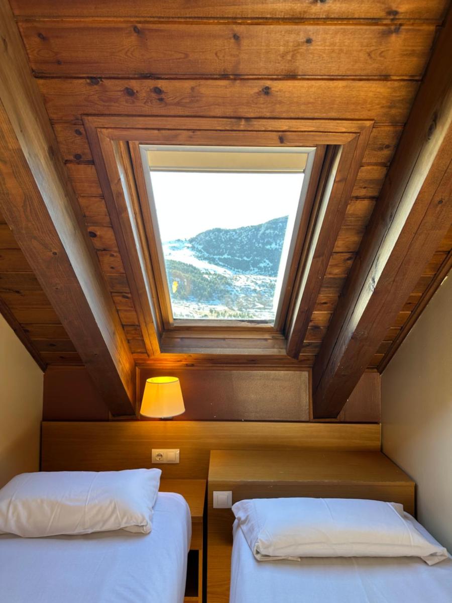 Cama o camas de una habitación en Aparthotel Siente Boí & SPA