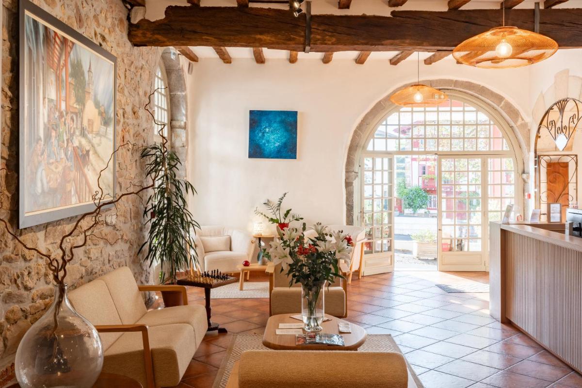 un salon avec un canapé et une table dans l'établissement Hôtel Restaurant & Spa La Maison Oppoca, à Ainhoa