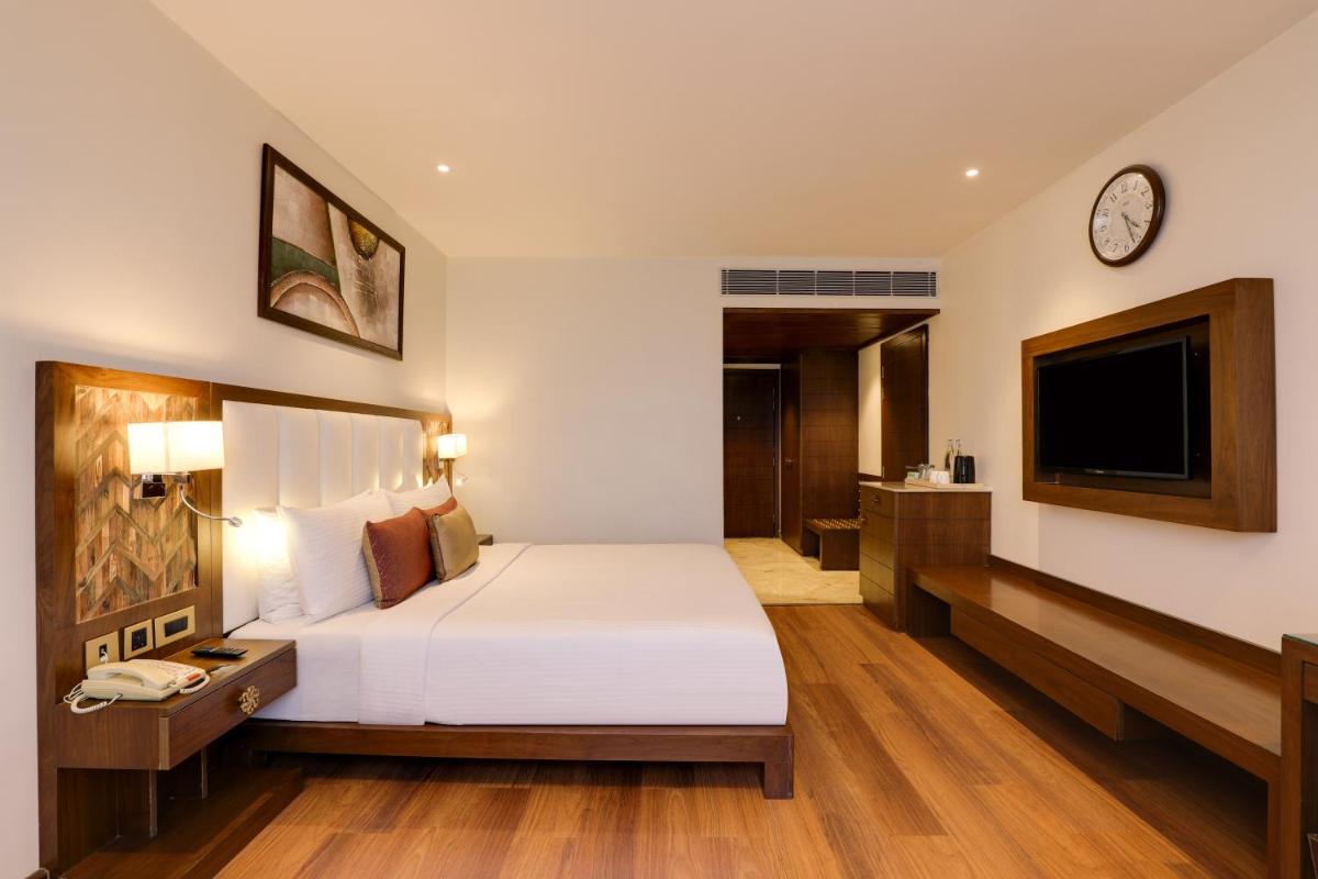 a hotel room with a bed and a tv at Saura Hotel, Agra - A Club Mahindra Associate in Agra