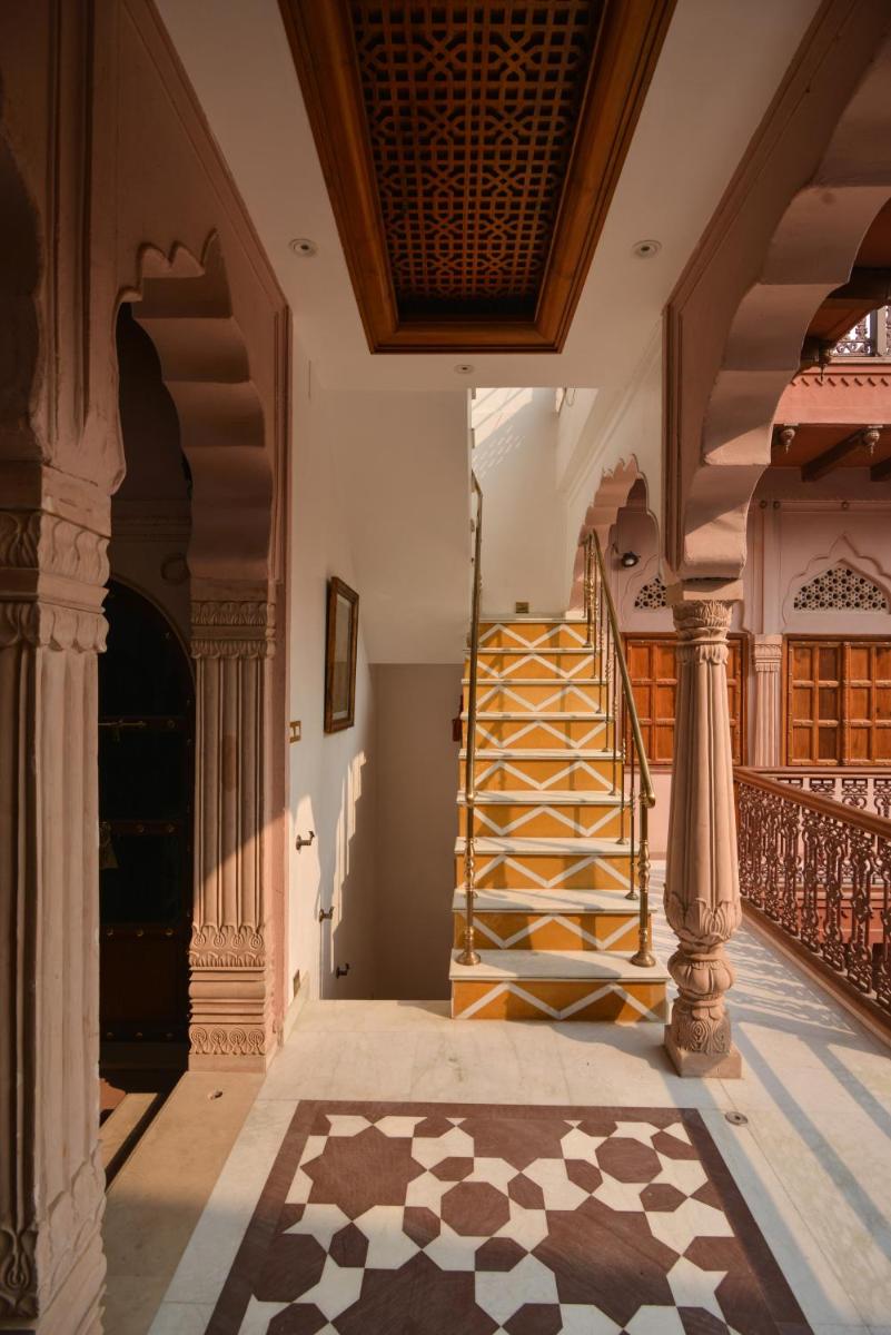 a spiral staircase in a building with a lobby at Haveli Dharampura & Golden Haveli- UNESCO awarded Boutique Heritage Hotel in New Delhi a spiral staircase in a building with a lobby at Haveli Dharampura & Golden Haveli- UNESCO awarded Boutique Heritage Hotel in New Delhi