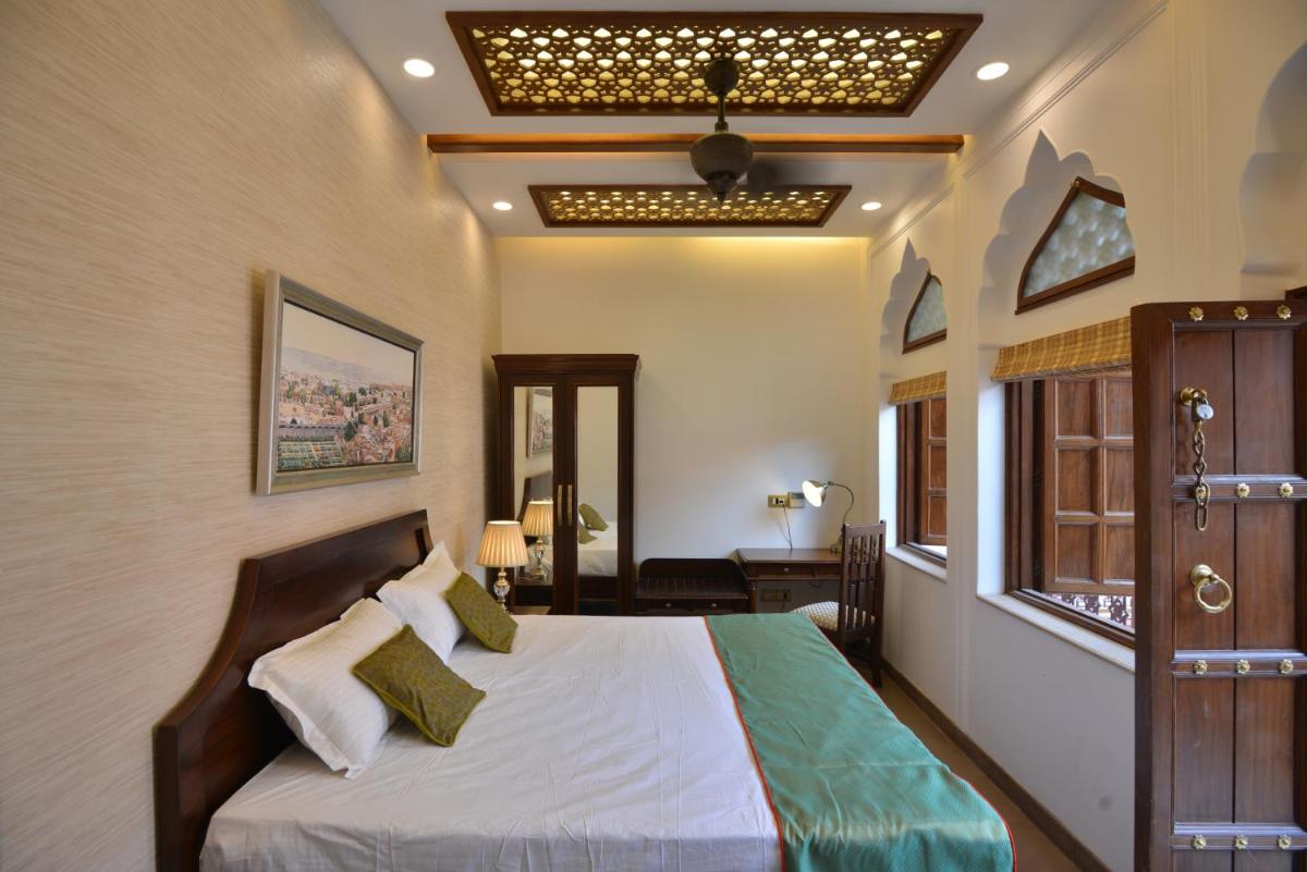 a bedroom with a large bed in a room at Haveli Dharampura & Golden Haveli- UNESCO awarded Boutique Heritage Hotel in New Delhi a bedroom with a large bed in a room at Haveli Dharampura & Golden Haveli- UNESCO awarded Boutique Heritage Hotel in New Delhi