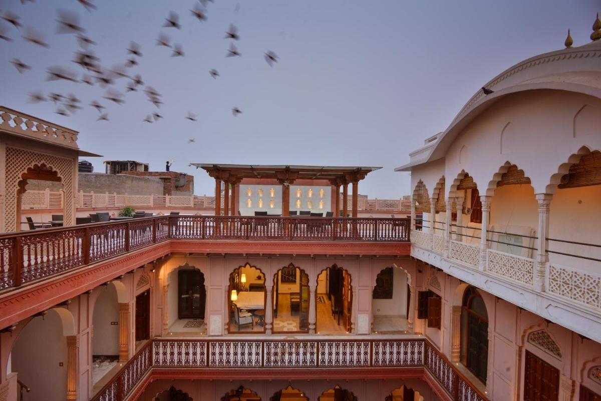 a view of a building with a balcony at Haveli Dharampura & Golden Haveli- UNESCO awarded Boutique Heritage Hotel in New Delhi a view of a building with a balcony at Haveli Dharampura & Golden Haveli- UNESCO awarded Boutique Heritage Hotel in New Delhi