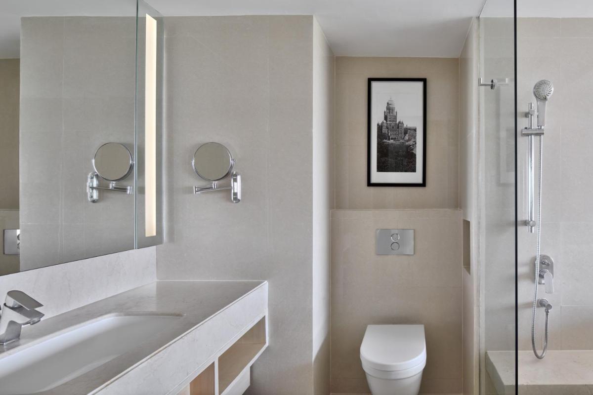 a white bathroom with a sink and a toilet at The Westin Mumbai Powai Lake in Mumbai