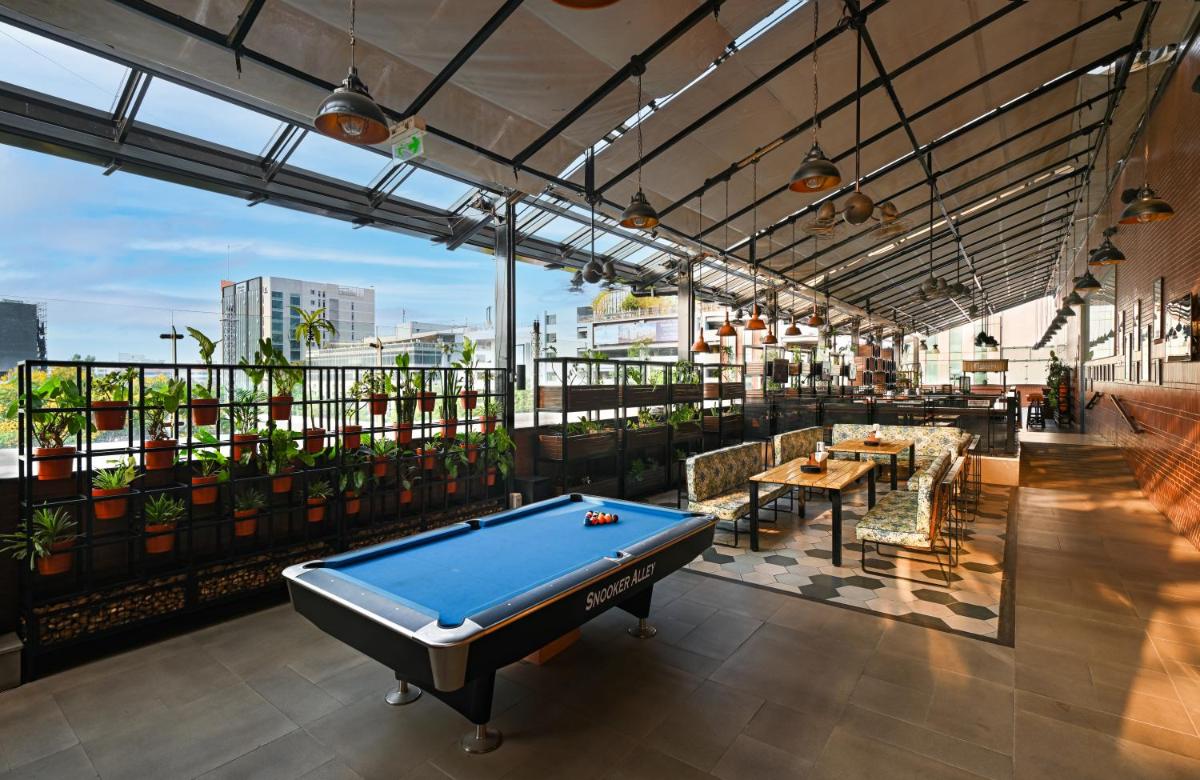a pool table in a room with plants at Sheraton Grand Bangalore Hotel at Brigade Gateway in Bengaluru