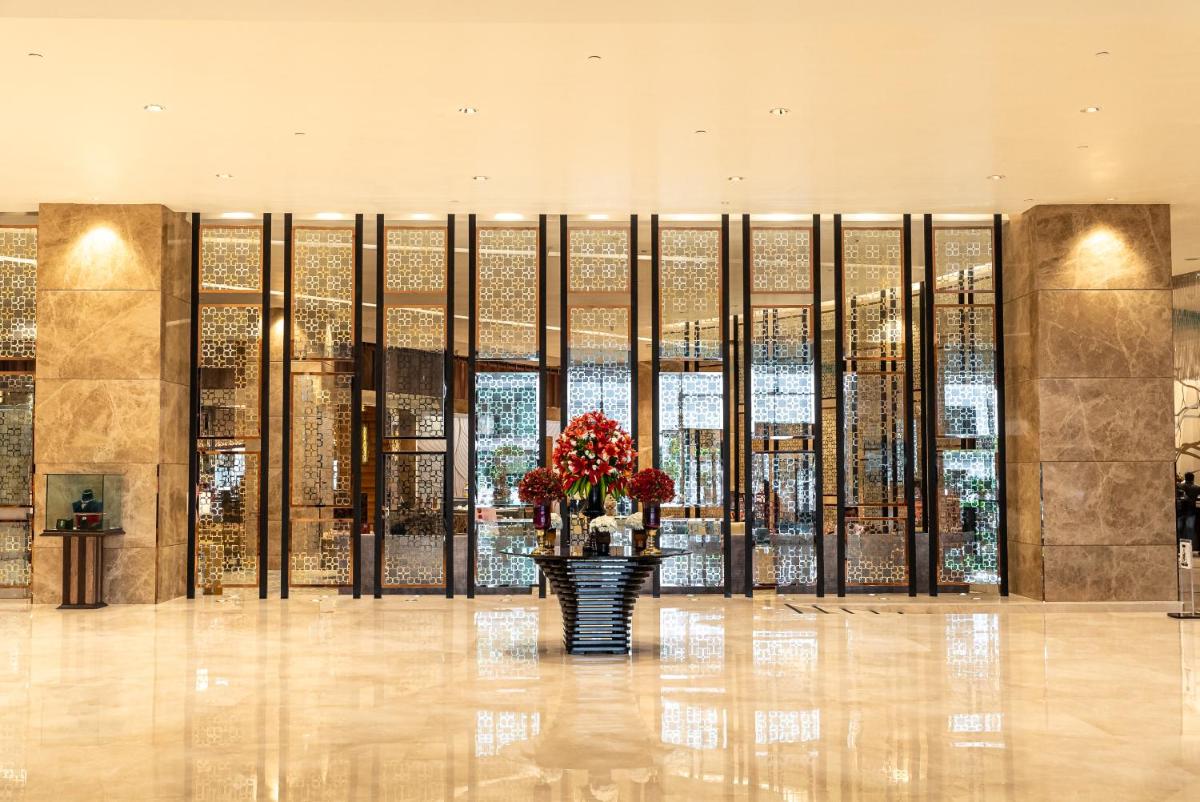 a lobby with a vase with flowers in it at Sheraton Grand Bangalore Hotel at Brigade Gateway in Bengaluru