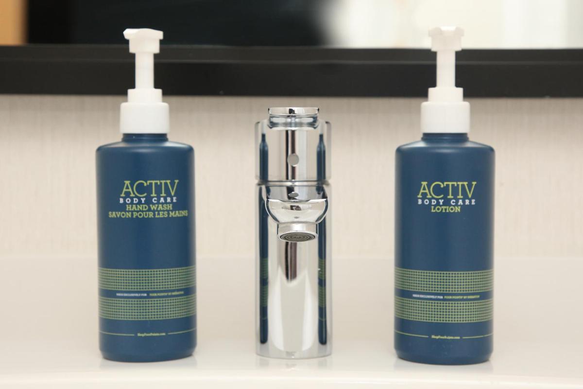 two bottles of authority hair gel and a hair brush at Four Points by Sheraton Hotel and Serviced Apartments Pune in Pune