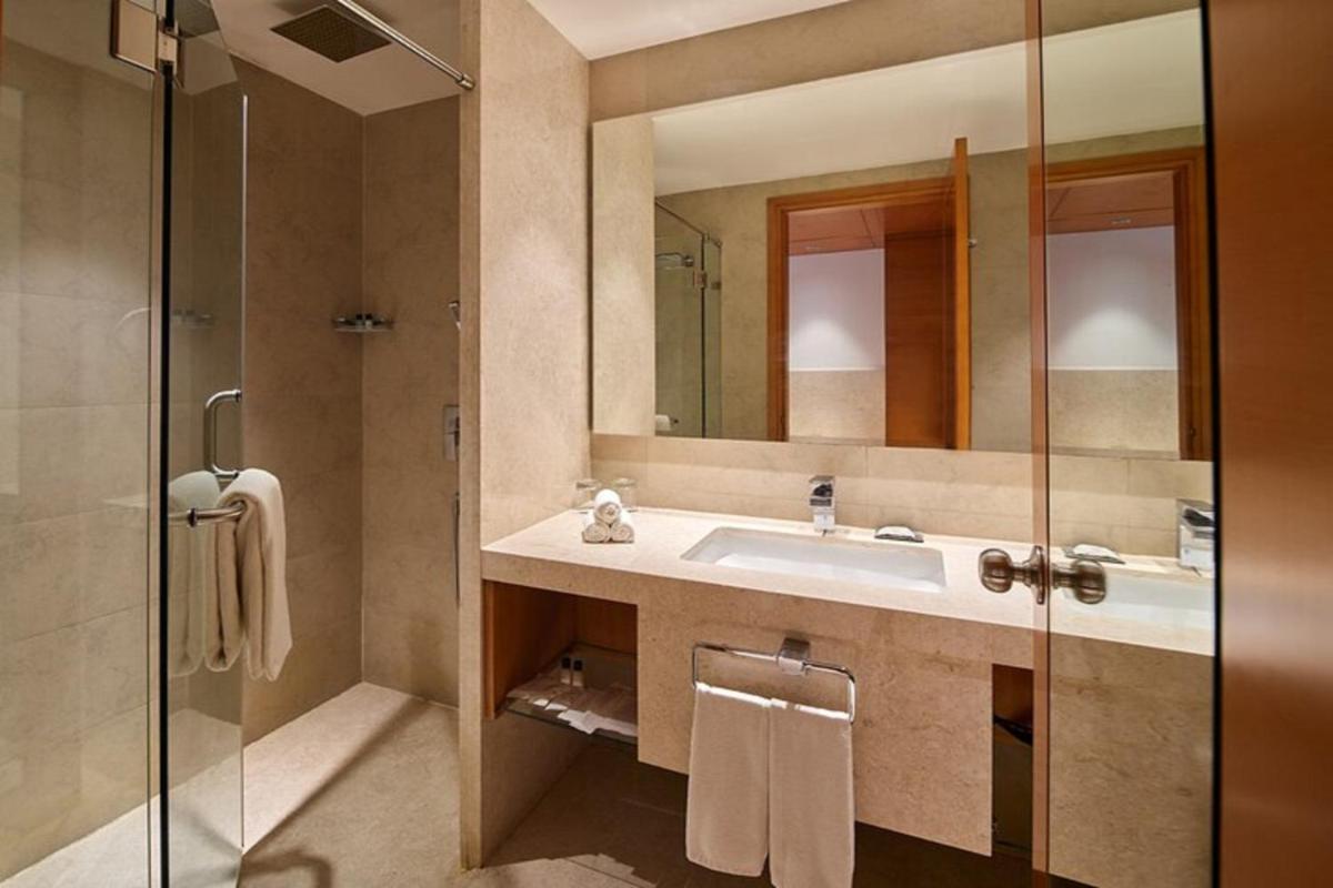 a bathroom with a sink and a shower at Mercure Hyderabad KCP Banjara Hills, An Accor Hotel in Hyderabad