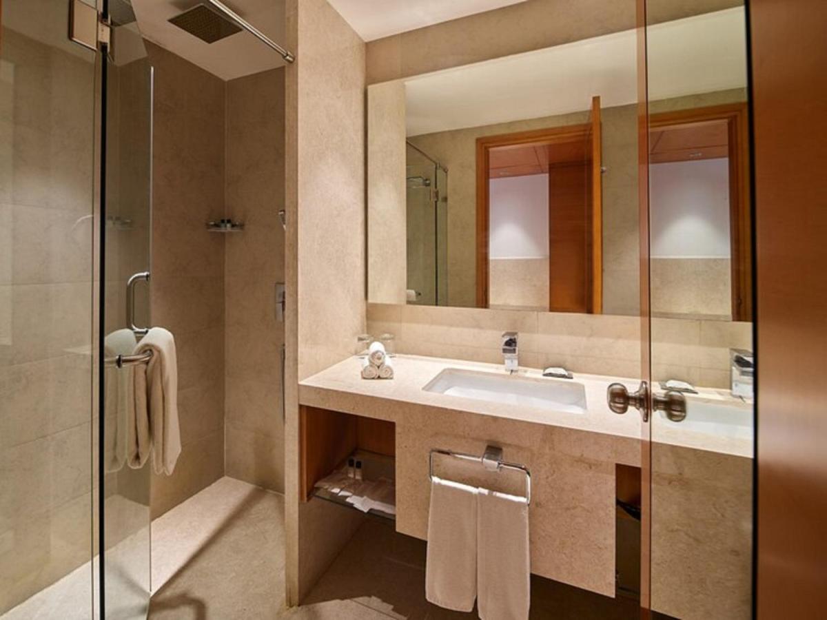 a bathroom with a sink and a shower at Mercure Hyderabad KCP Banjara Hills, An Accor Hotel in Hyderabad