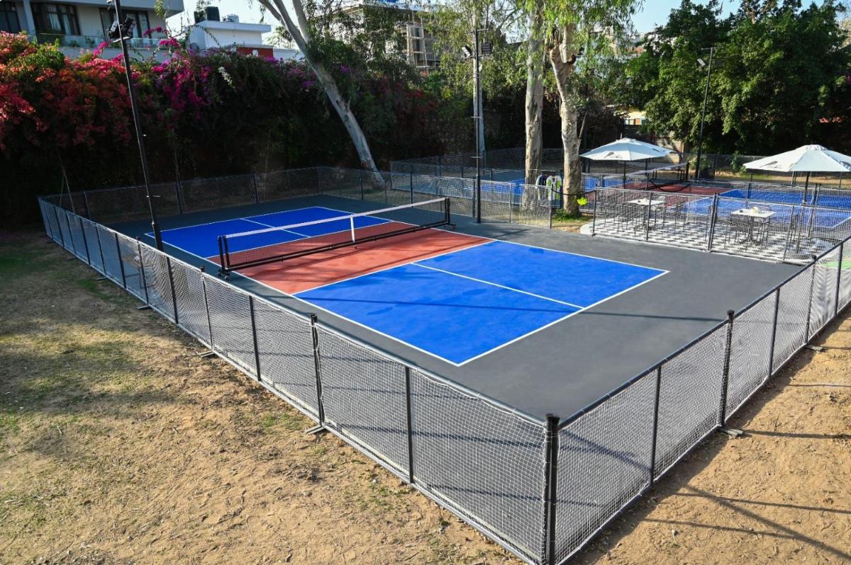 a tennis court with two tennis courts at Brij Nest, Jaipur - An All Suite Boutique Hotel in Jaipur