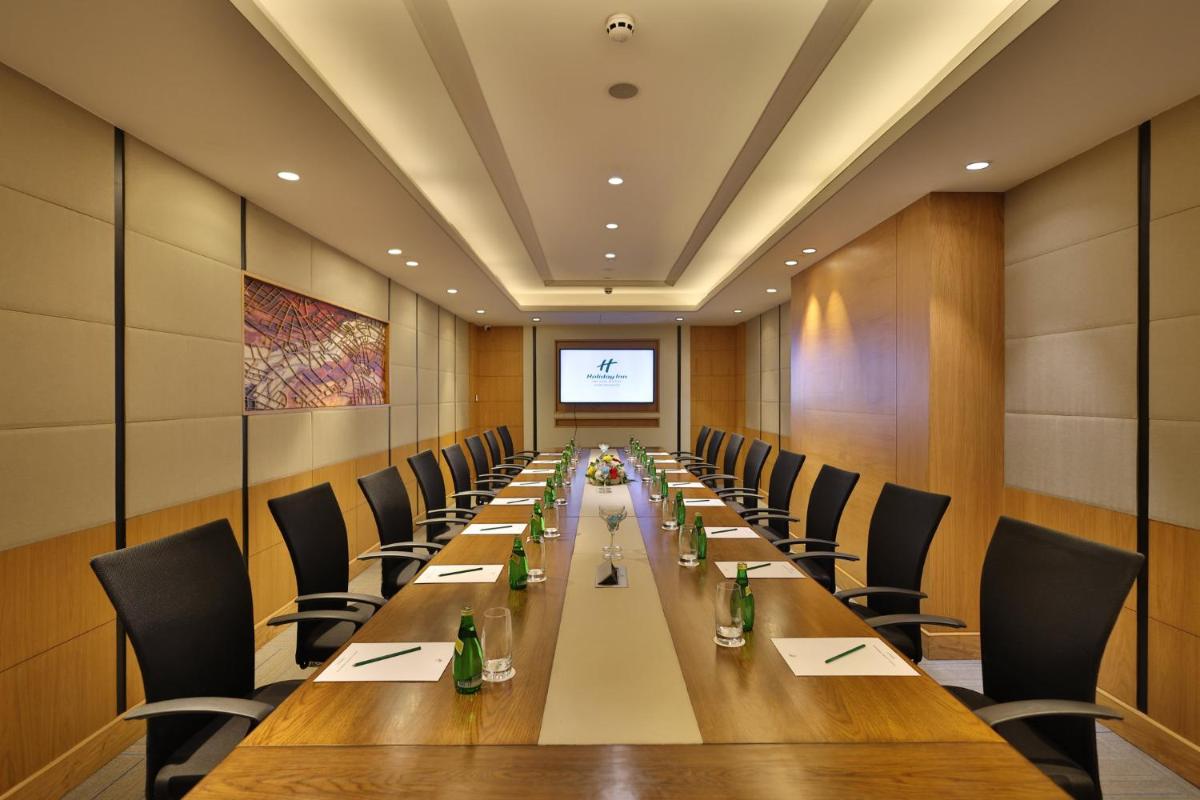 a large conference room with a long table and chairs at Holiday Inn Agra MG Road an IHG Hotel in Agra