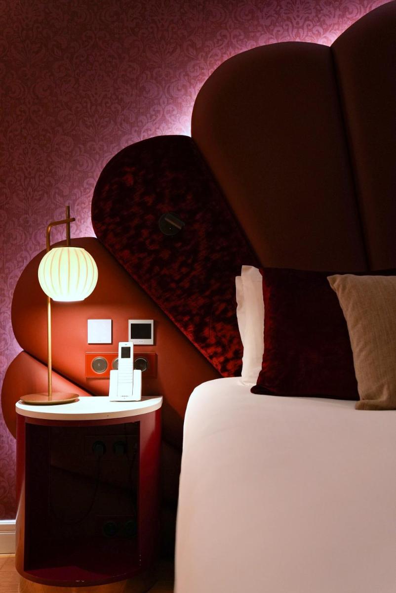 Un ou plusieurs lits dans un hébergement de l'établissement Paris j'Adore Hotel & Spa