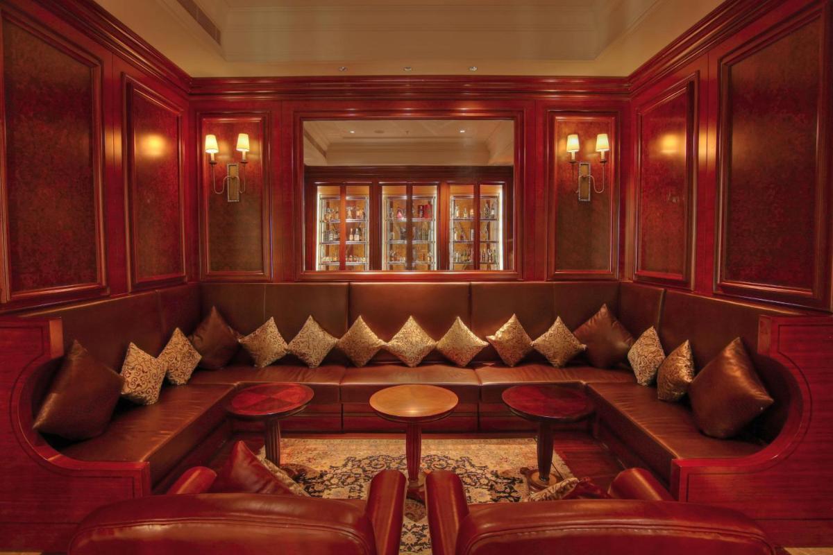 a pub with a bench and tables and chairs at JW Marriott Pune in Pune