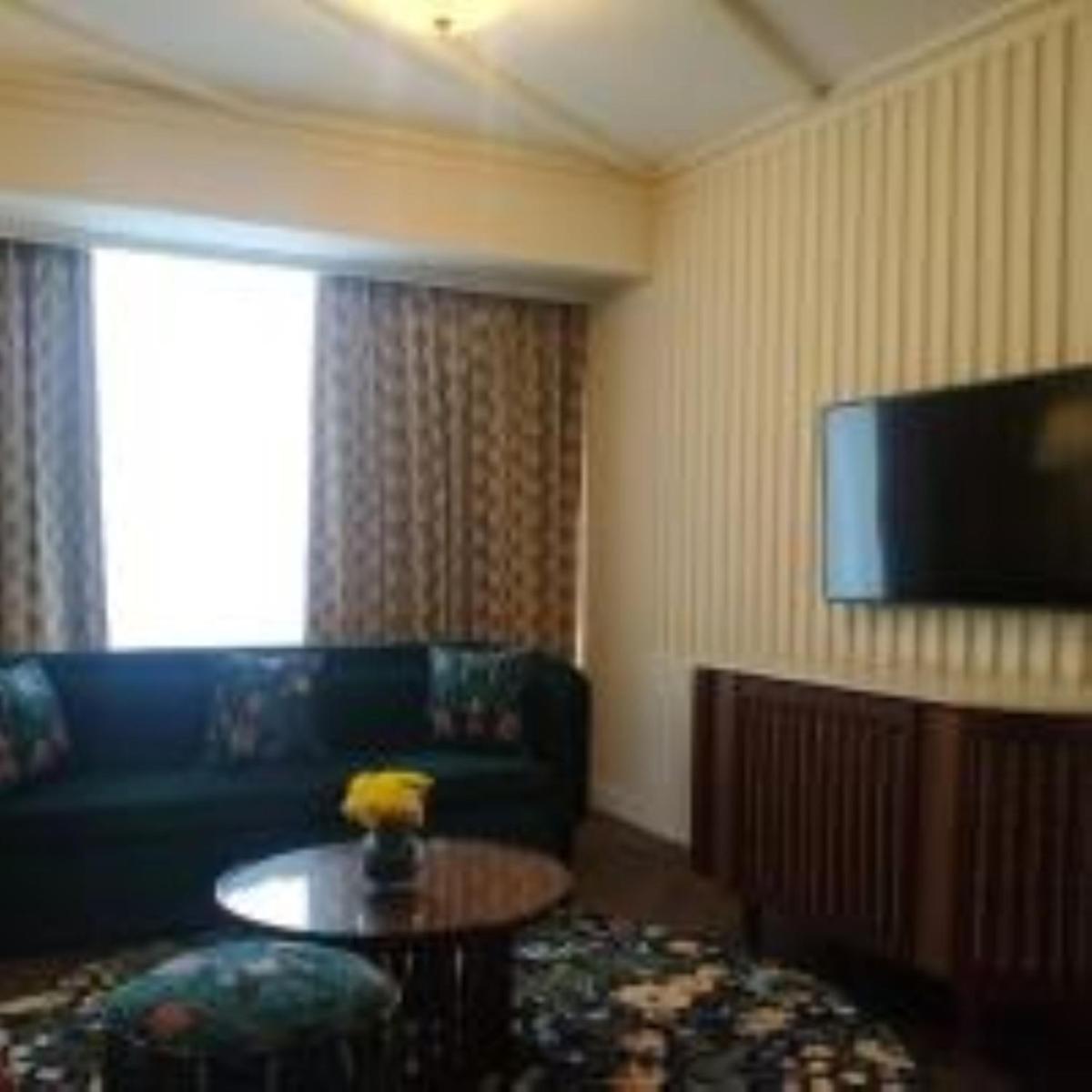 a living room with a couch and a table and a television at Blue Diamond Pune IHCL SeleQtions in Pune