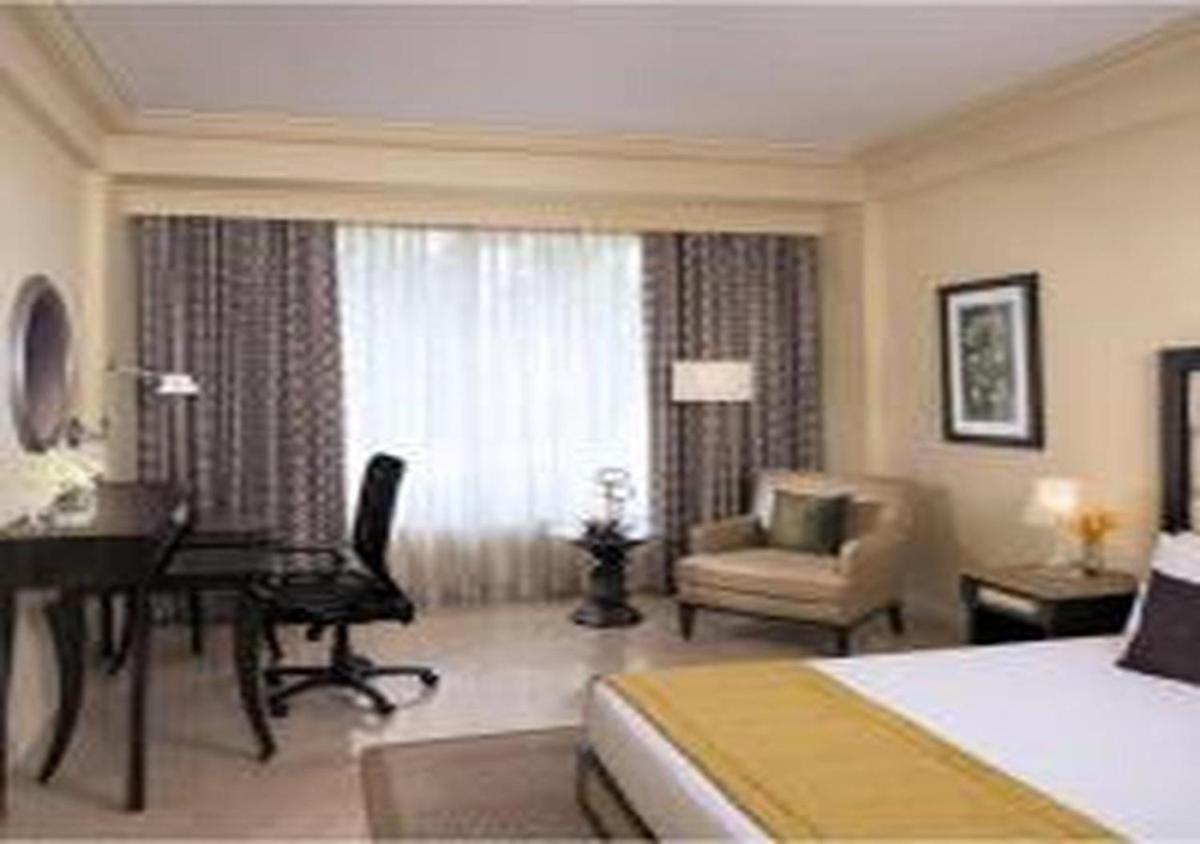 a hotel room with a bed and a desk and a bedroom at Blue Diamond Pune IHCL SeleQtions in Pune