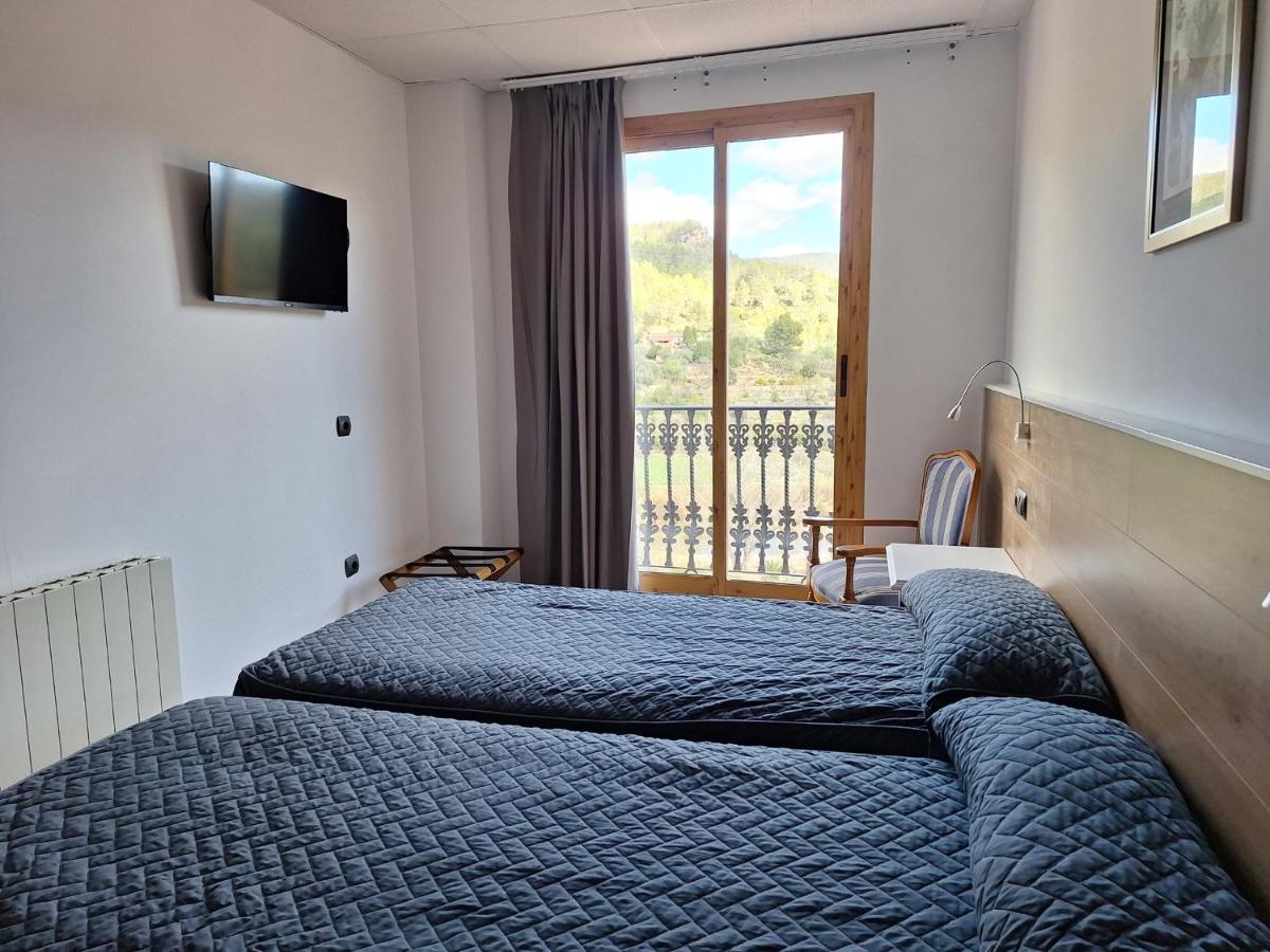 Cama o camas de una habitación en Hotel Xauen