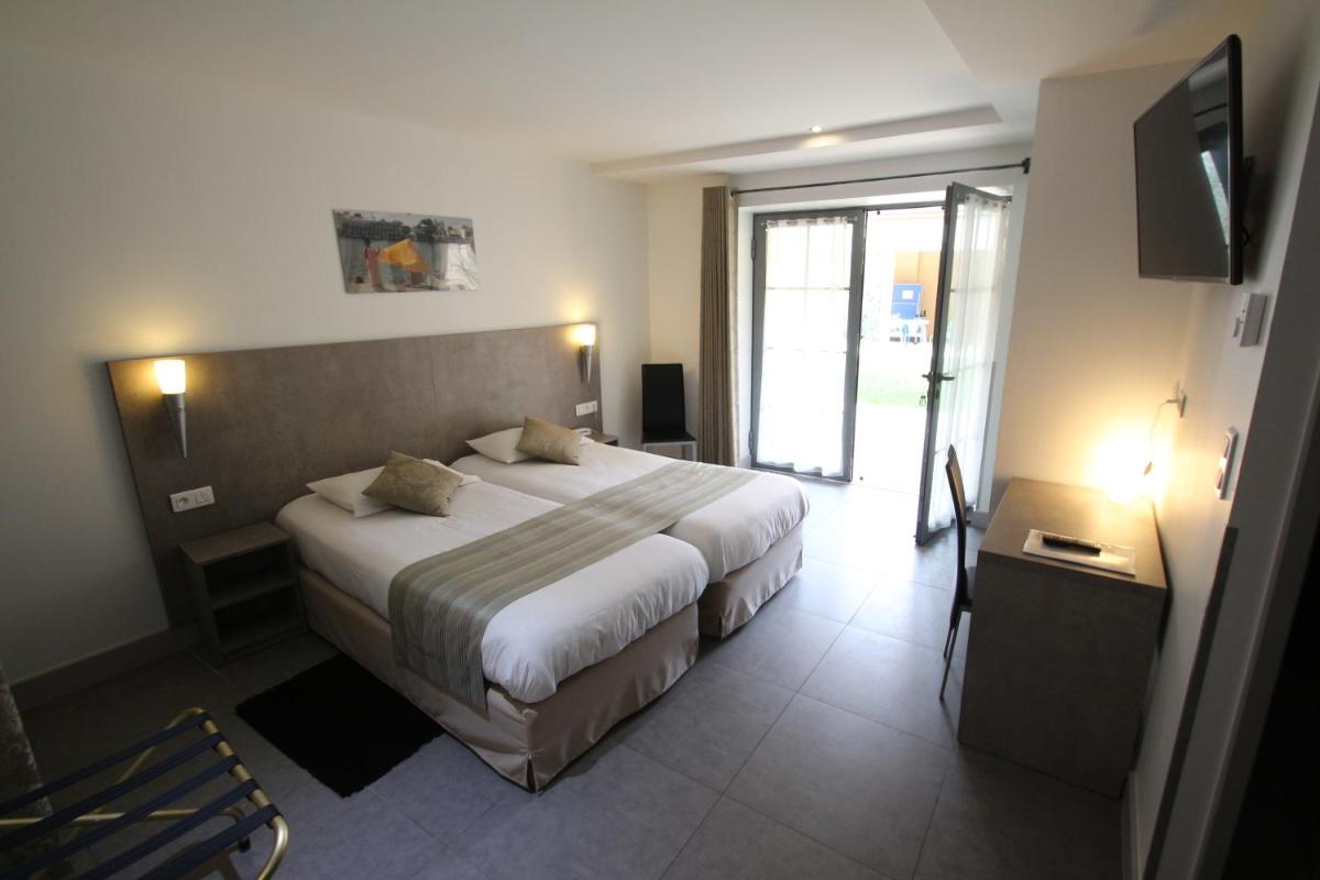 Un ou plusieurs lits dans un hébergement de l'établissement Logis Hotel Archambeau