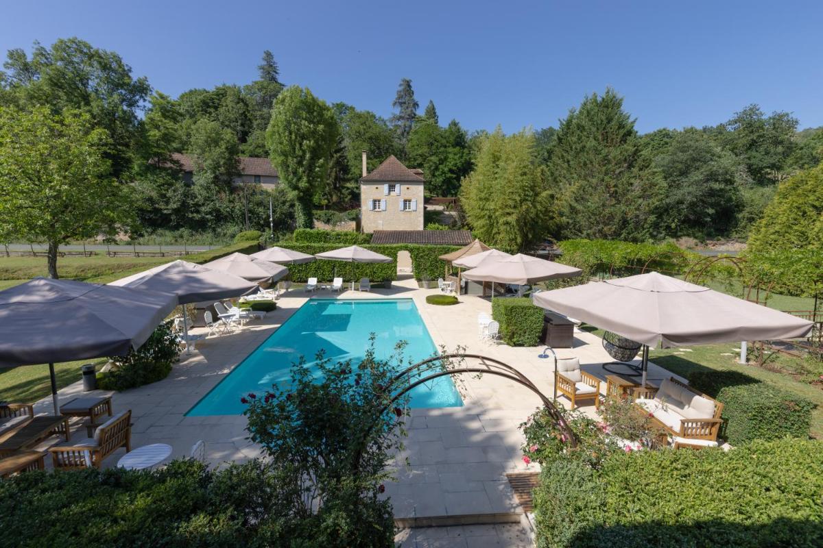 vue aérienne d'une piscine avec des parasols dans l'établissement Le Moulin de Mitou, à Auriac-du-Périgord