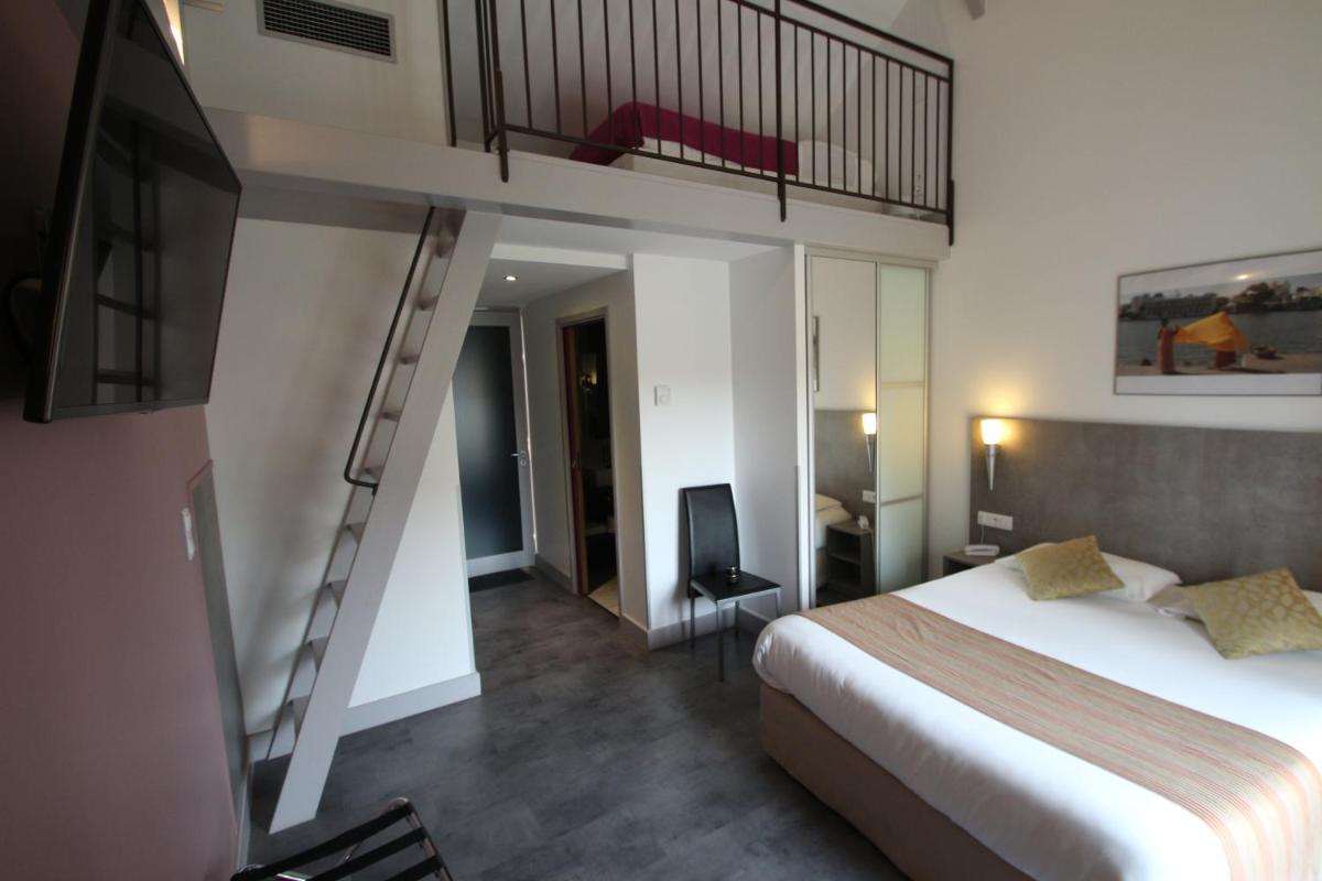 Un ou plusieurs lits dans un hébergement de l'établissement Logis Hotel Archambeau