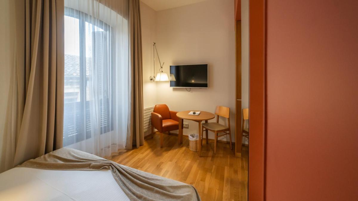 una habitación con una cama y una mesa y una ventana en Hotel Balneario Prats, en Caldes de Malavella 59 fotos más