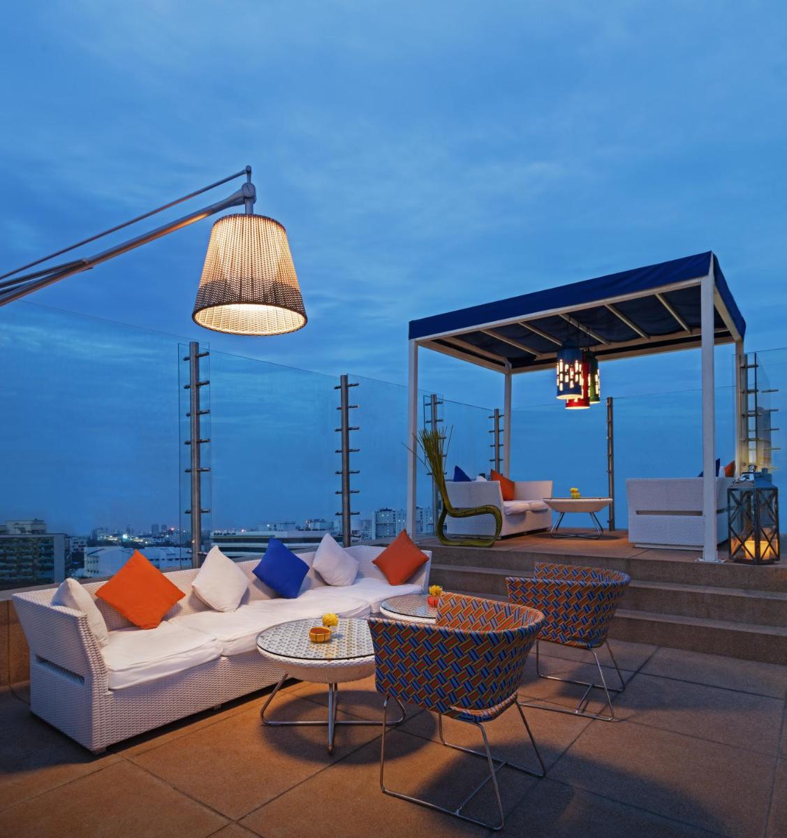 a living room with a couch and chairs on a roof at The Park Chennai in Chennai a living room with a couch and chairs on a roof at The Park Chennai in Chennai