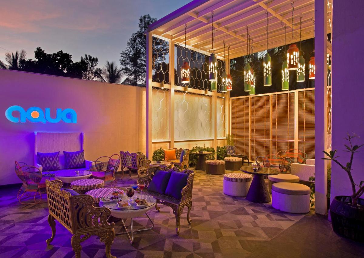a patio with chairs and tables in front of a building at The Park Bangalore, MG Road in Bengaluru a patio with chairs and tables in front of a building at The Park Bangalore, MG Road in Bengaluru