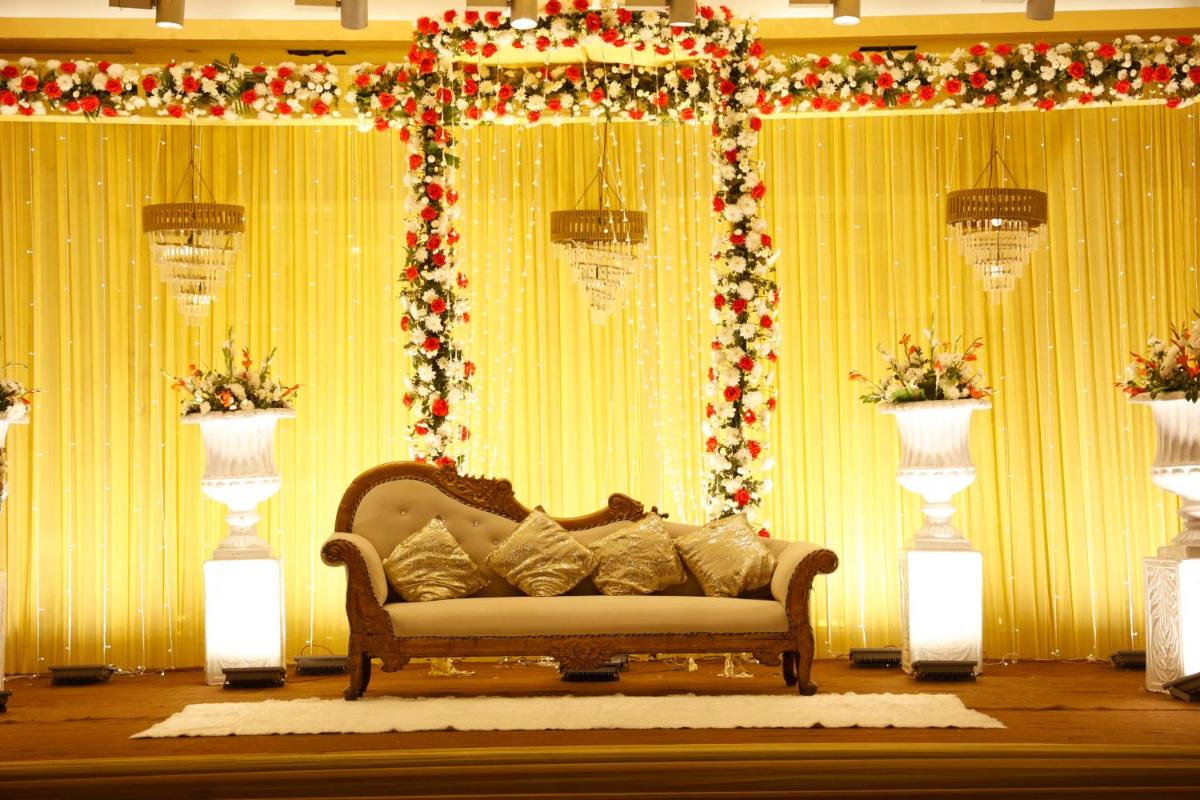 a couch in front of a stage with christmas decorations at Radisson Blu Hotel New Delhi Paschim Vihar in New Delhi a couch in front of a stage with christmas decorations at Radisson Blu Hotel New Delhi Paschim Vihar in New Delhi