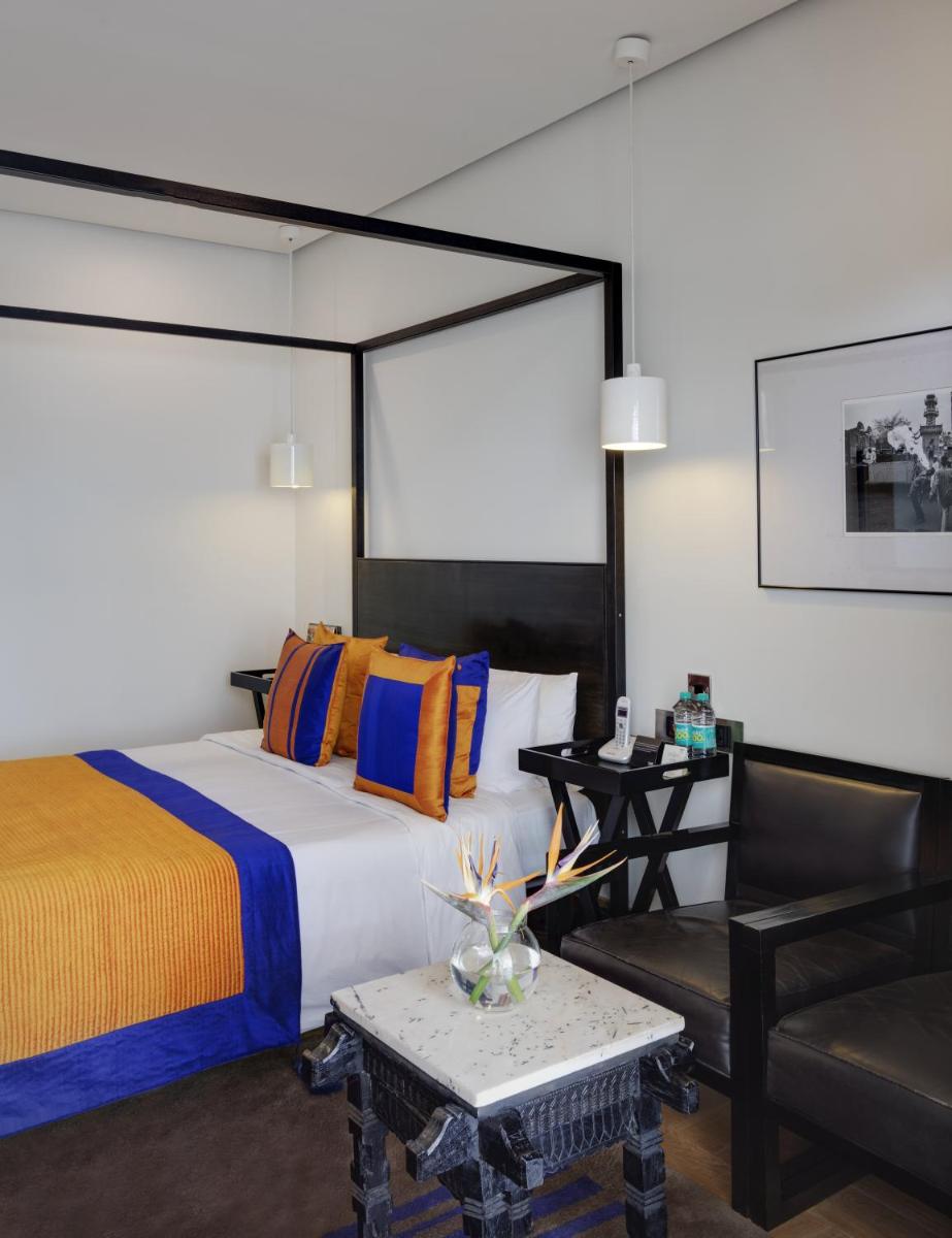 a bedroom with a bed and a table and a chair at The Park Bangalore, MG Road in Bengaluru a bedroom with a bed and a table and a chair at The Park Bangalore, MG Road in Bengaluru