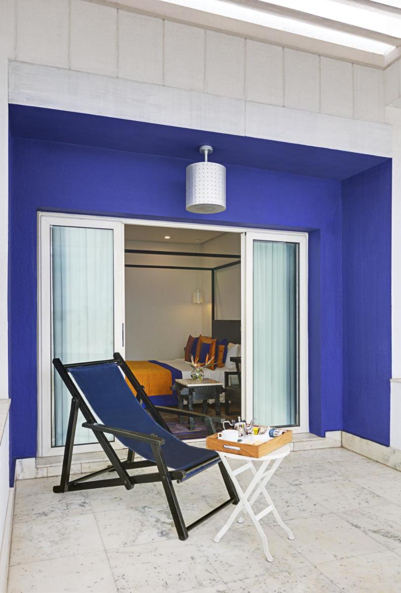 a blue room with a chair and a living room at The Park Bangalore, MG Road in Bengaluru a blue room with a chair and a living room at The Park Bangalore, MG Road in Bengaluru