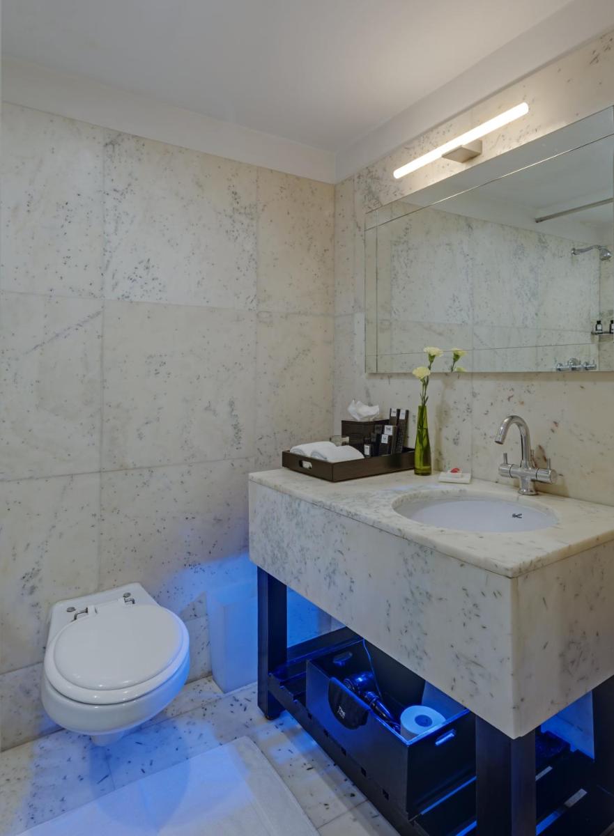 a bathroom with a sink and a toilet at The Park Bangalore, MG Road in Bengaluru a bathroom with a sink and a toilet at The Park Bangalore, MG Road in Bengaluru