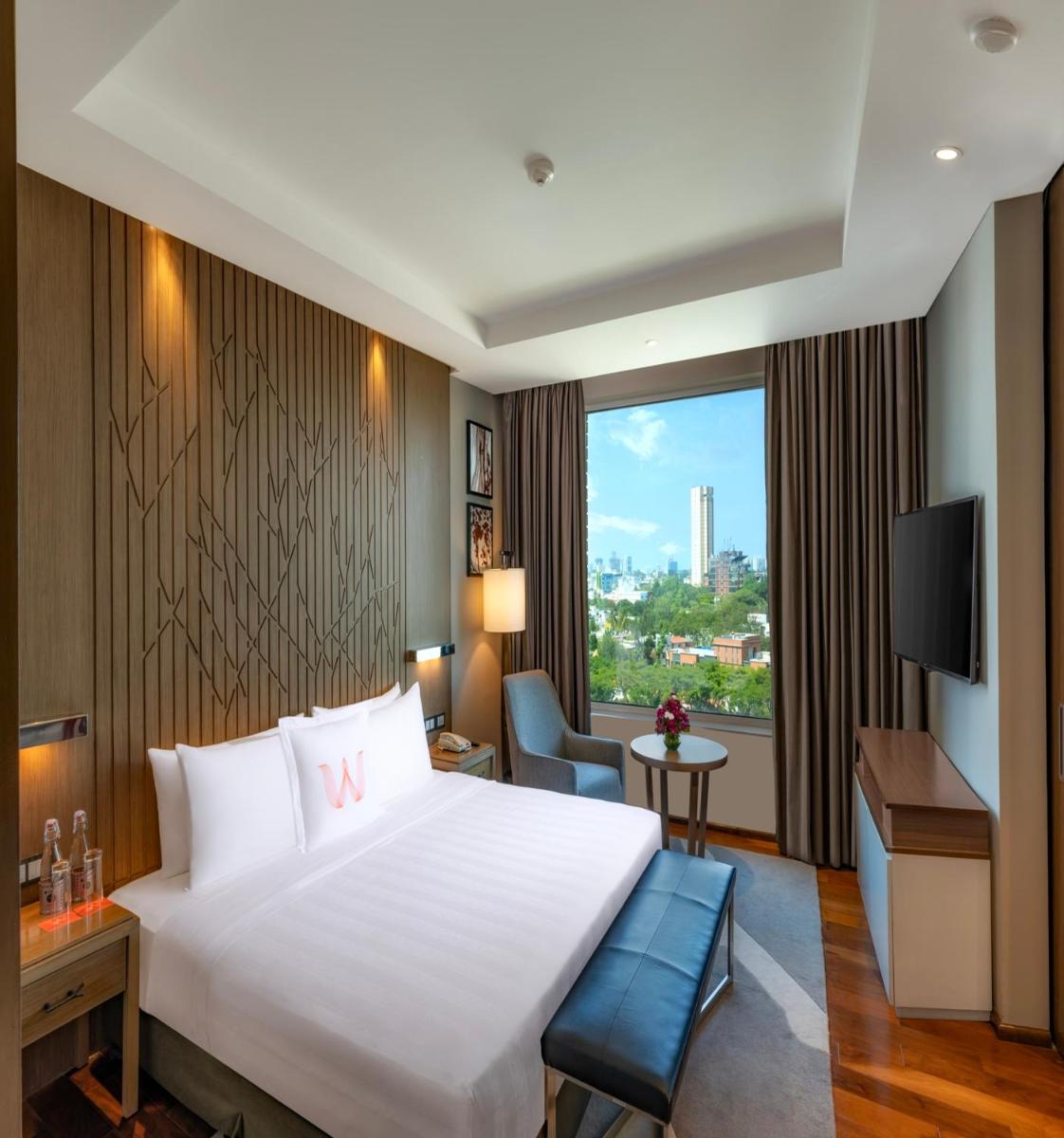 a hotel room with a large white bed and a window at Welcomhotel by ITC Hotels, Richmond Road, Bengaluru in Bengaluru