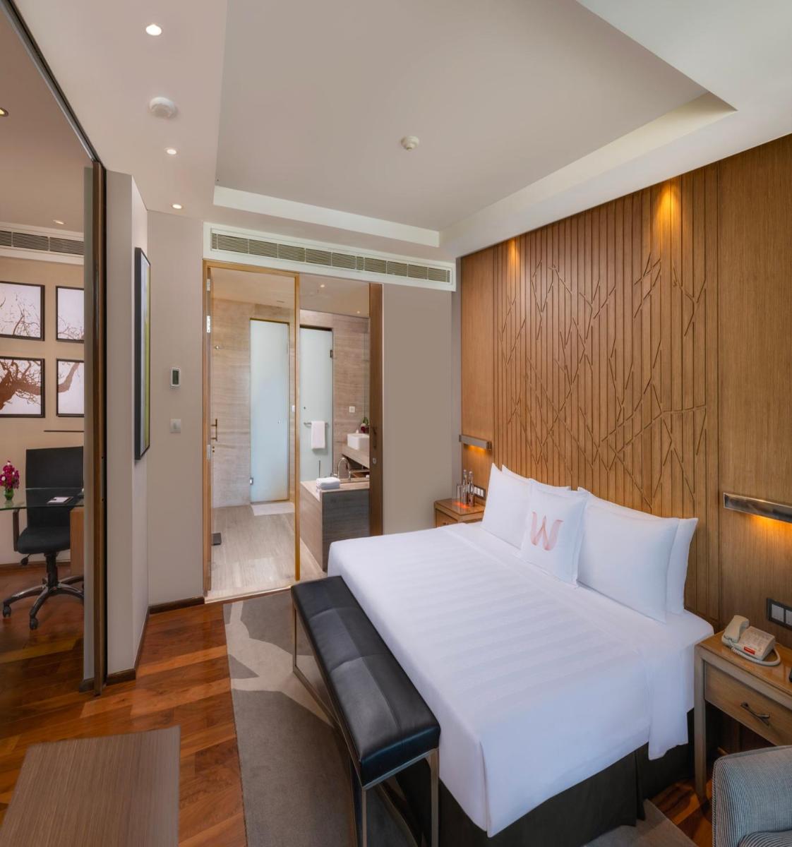 a bedroom with a large white bed and a desk at Welcomhotel by ITC Hotels, Richmond Road, Bengaluru in Bengaluru
