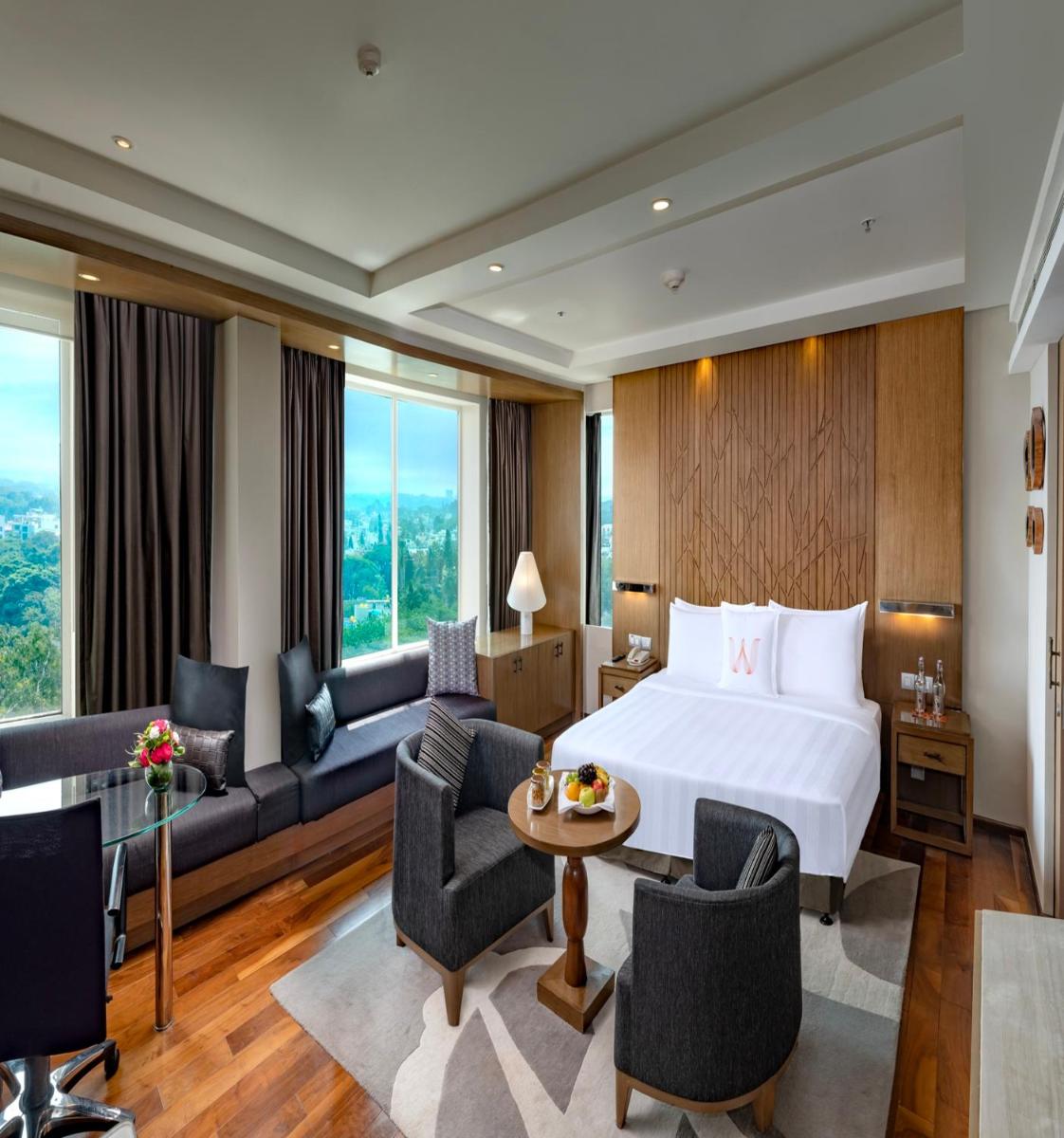 a hotel room with a bed and a couch at Welcomhotel by ITC Hotels, Richmond Road, Bengaluru in Bengaluru